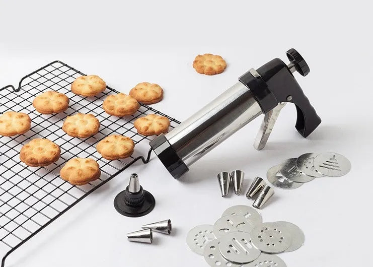 Stainless steel biscuit press cookie gun with assortment of metal cookie molds and piping nozzles