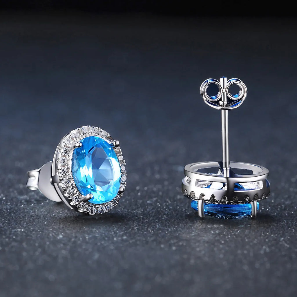 925 sterling silver blue topaz jewellery set showing necklace, ring, earrings and pendant with geometric design