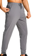 Men's solid-colour loose casual trousers in polyester fabric, shown in one of twelve available colour codes.