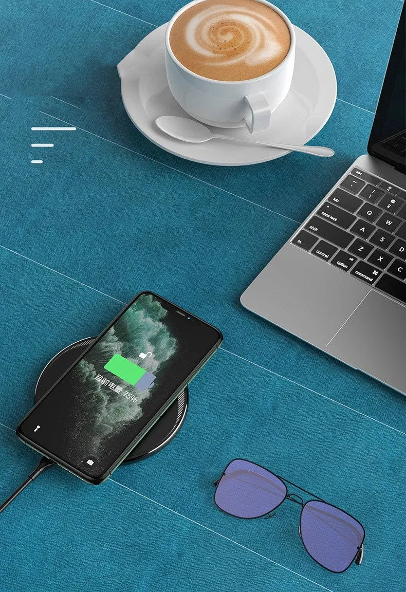 Black circular wireless disc charger for mobile phones with LED indicator light