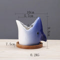 Blue ceramic cartoon succulent flowerpot with drainage hole on a desktop