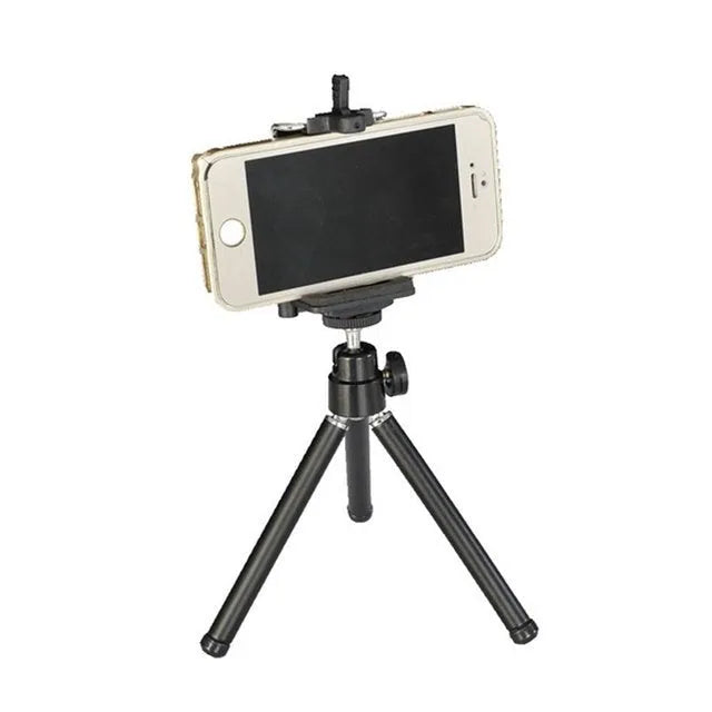Mini flexible aluminium desktop tripod with ball head extended, alongside a universal U-shaped black phone clip.