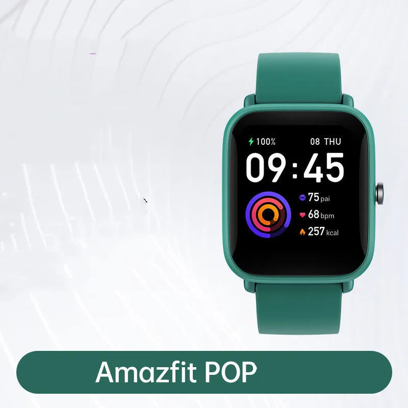 Smart watch with colour screen and green silicone strap on wrist, showing fitness data.