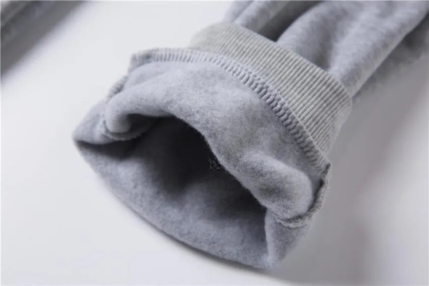 Men's loose-fit casual sweater suit with letter print in black, showing top and matching pants.
