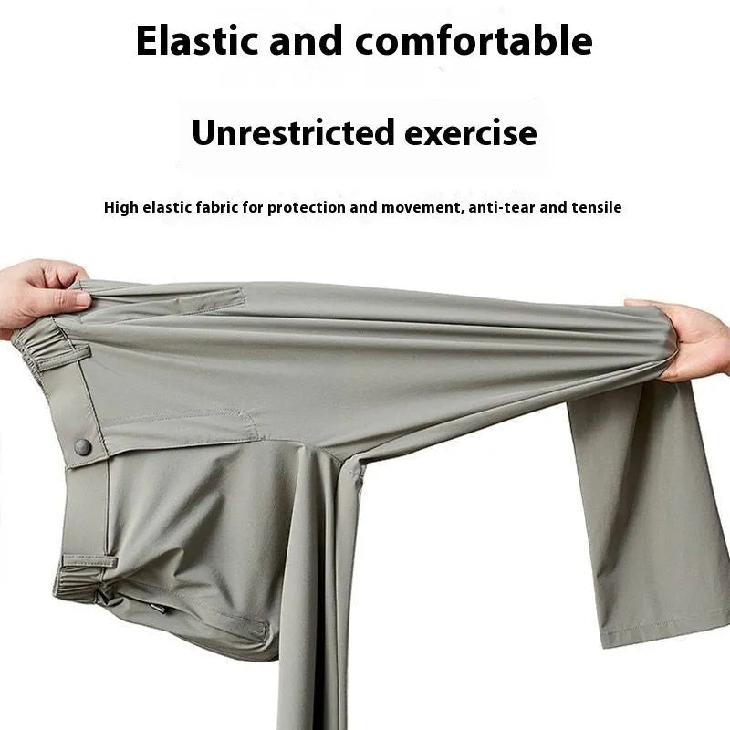Man wearing loose-fit black ice silk straight-leg trousers with an elastic waistband.