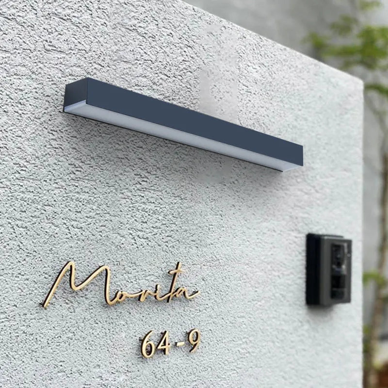 Black solar-powered outdoor wall lamp with strip design for garden and yard lighting