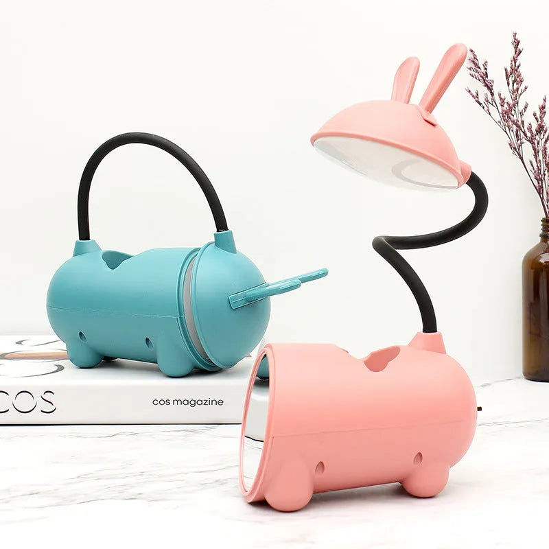 Cartoon-themed plastic desk lamp with USB power and pen storage compartment in dark blue colour