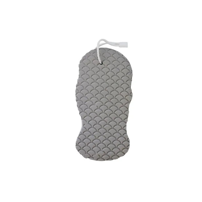 White 3D fish scale pattern bath sponge with hang loop on a bathroom background.