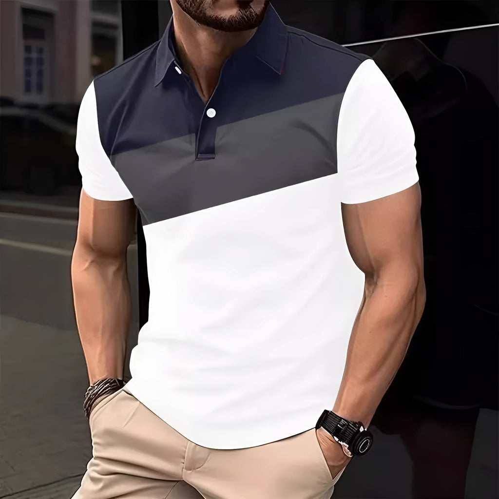 Man wearing a loose-fit grey T-shirt with a colourful 3D digital print pattern on the front.