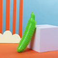 Green cucumber-shaped dog chew toy with a squeaker on a white background