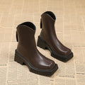 Black square toe platform Martin boots for women with a back zipper and a mid-calf height.