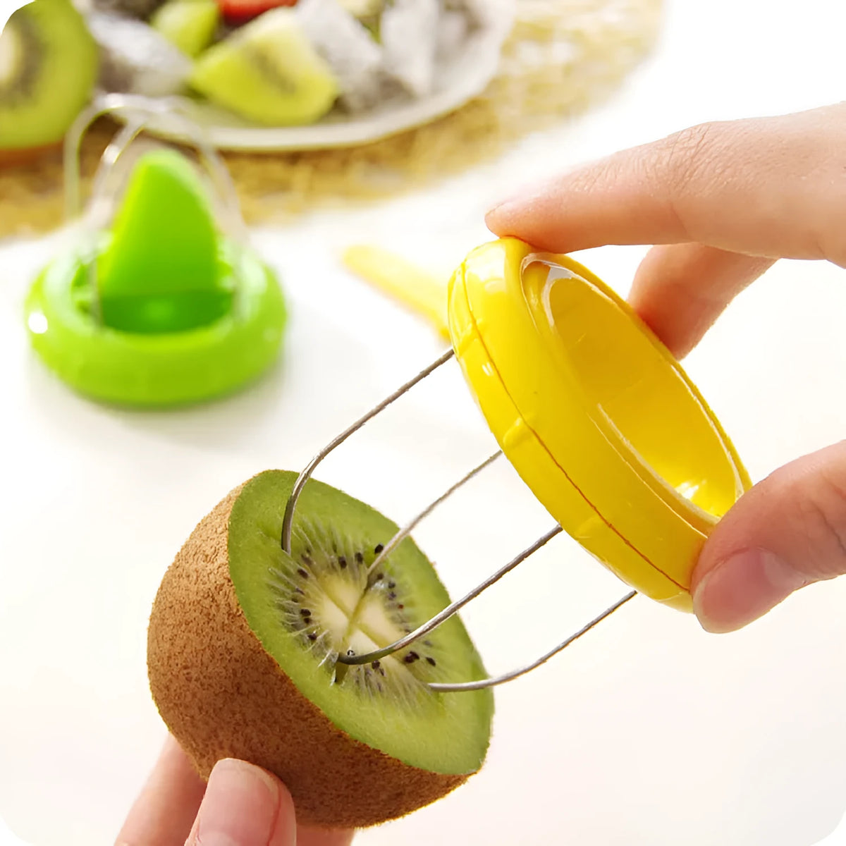 Mini kiwi cutter peeler slicer with stainless steel blade and ABS body on a kitchen surface