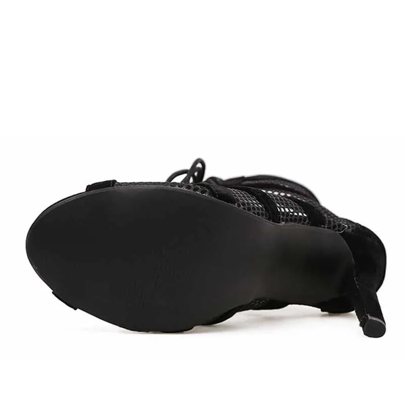 Black suede women's lace-up high heel shoes showing 11.5cm heel and ankle fastening