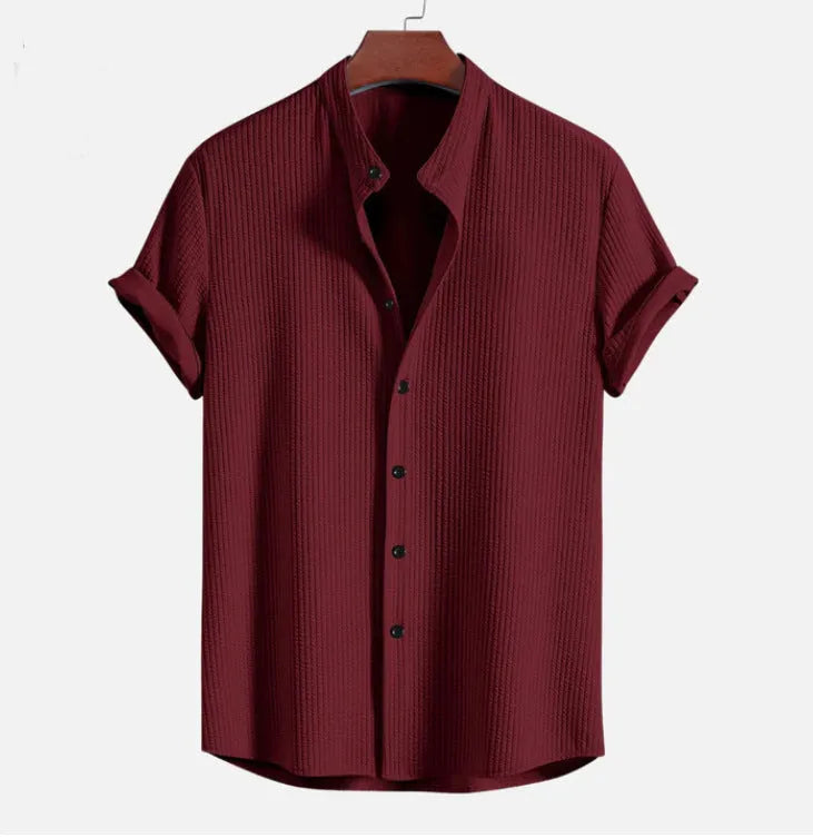 Men's loose fit short sleeve polyester shirt shown in a light blue colour on a hanger.
