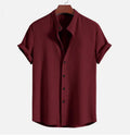 Men's loose fit short sleeve polyester shirt shown in a light blue colour on a hanger.