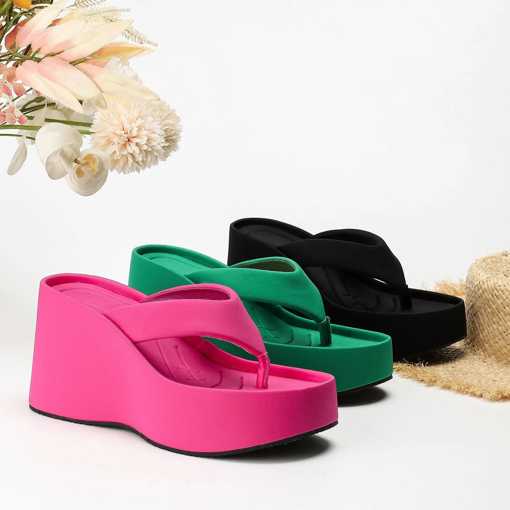 Pair of thick soled slippers for women with PU upper and rubber sole