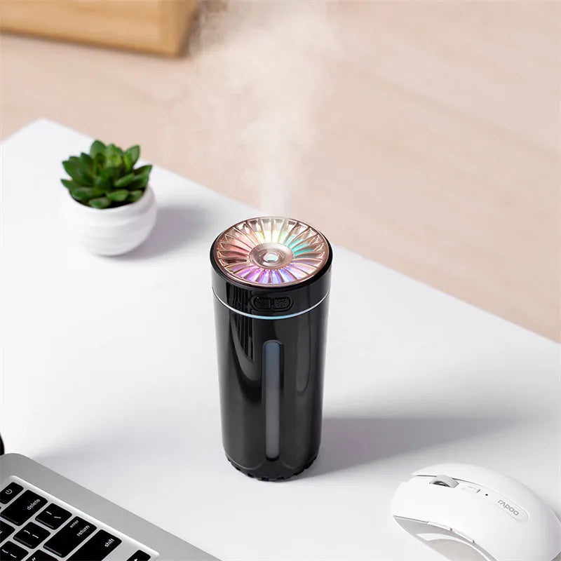 Black USB rechargeable car humidifier with colourful lights showing mist output, sized for cup holders