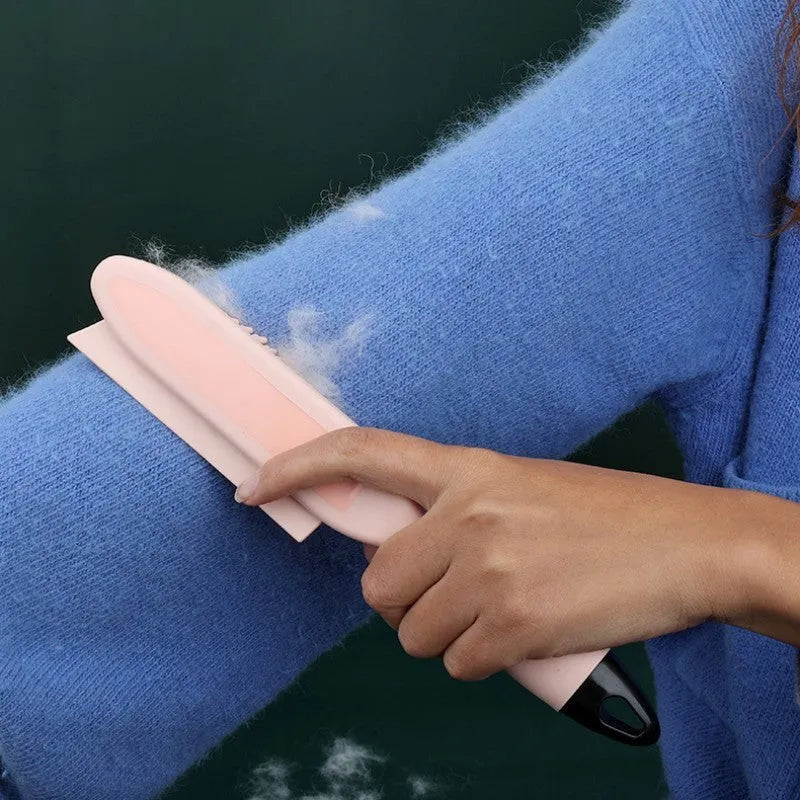 Green and pink dual-use dog brush and sticky clothes hair remover for pet grooming.