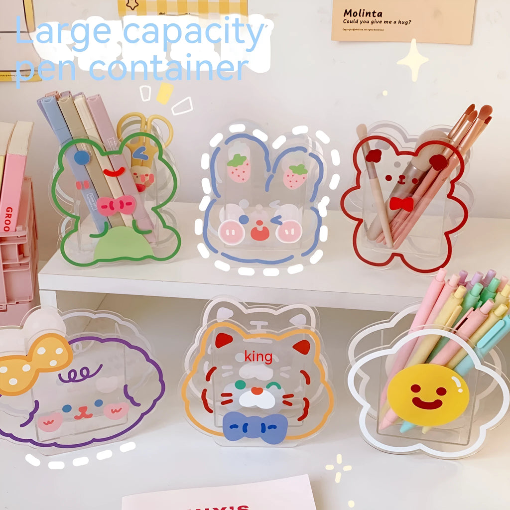 Clear square acrylic storage box with a cute illustrated strawberry rabbit design on a desk with pens.