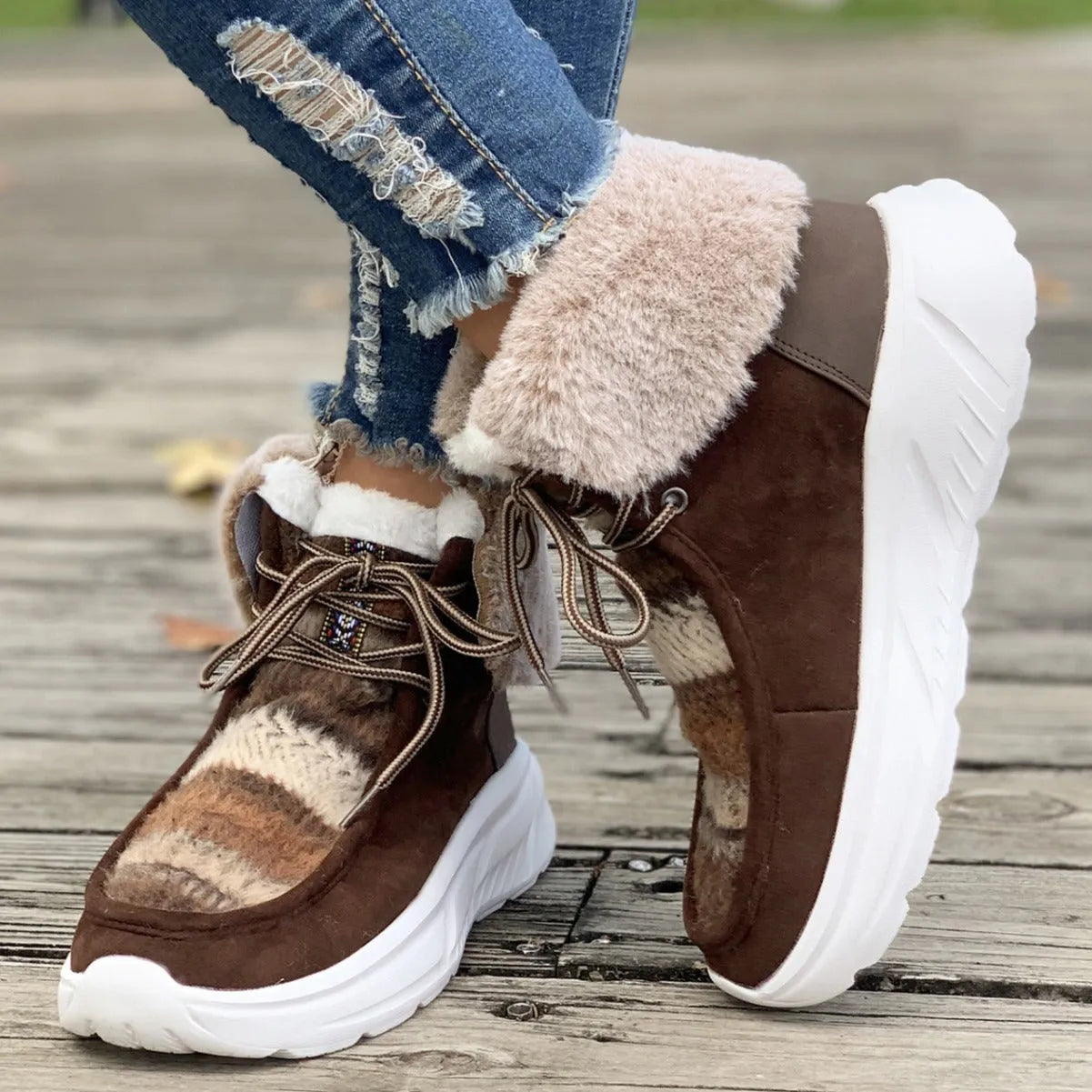 Women's beige fuzzy suede lace-up snow boots with thick rubber sole and plush lining.