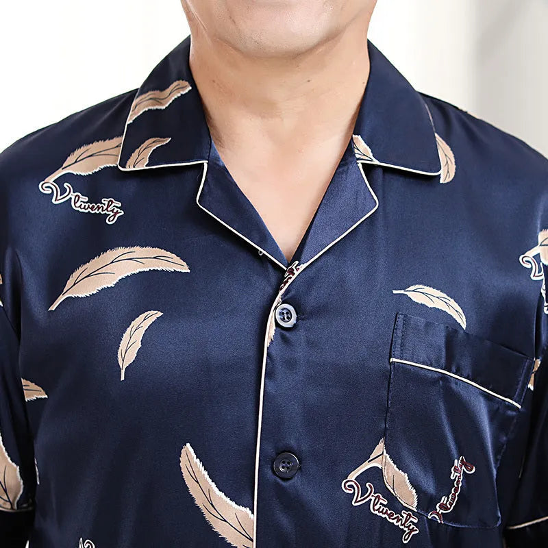 Men's ice silk pyjama set with front button top, small lapel collar, plant flower print, short sleeves and long trousers.