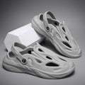 Men's breathable hollow-out EVA slippers in grey, flat heel, round toe, on a plain background