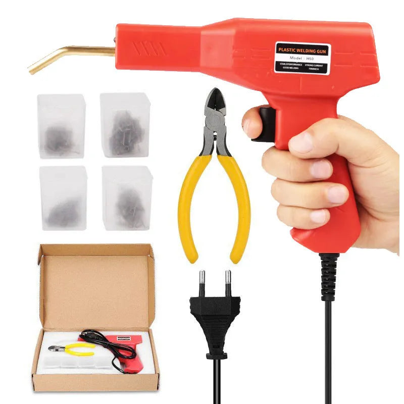 Red plastic welding gun with pure copper transformer in black plastic box with nails and pliers knife