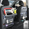 Black PU leather car seat organiser with multiple pockets hanging on a car headrest