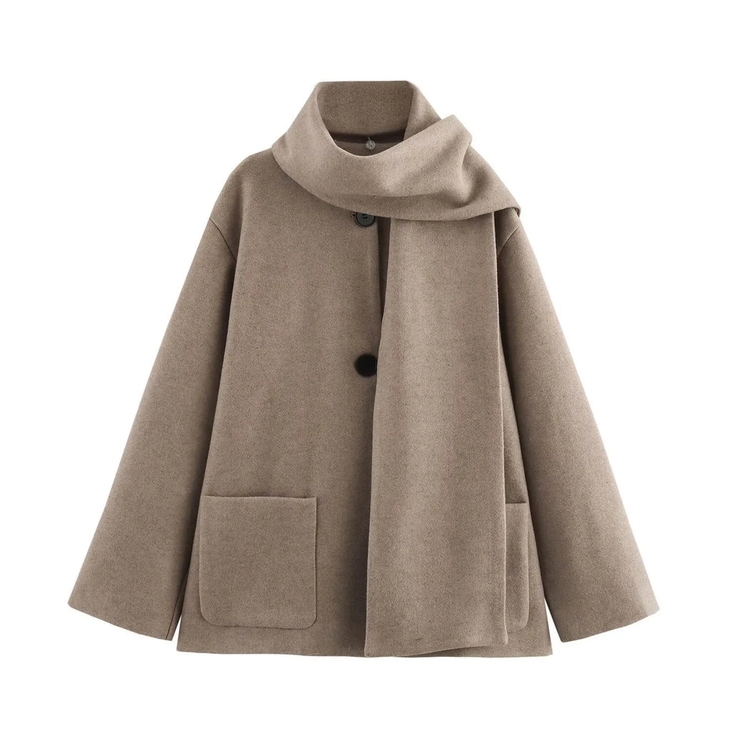 Women's long beige coat with a fluffy artificial fur collar and pockets.