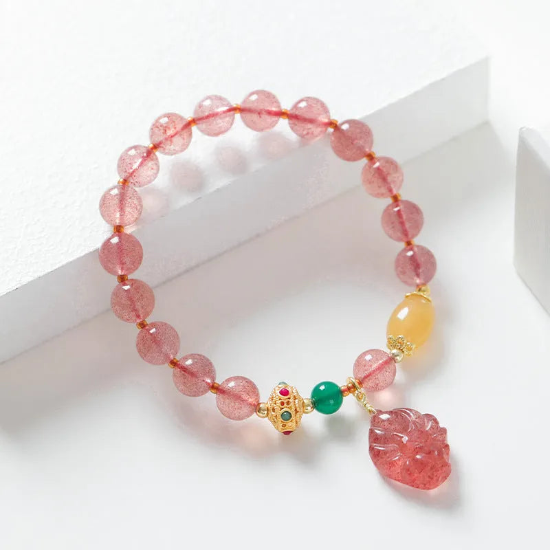 Close-up of a women's crystal beaded bracelet with a nine tail fox charm on a model's wrist.