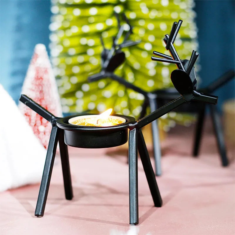 Black iron Christmas candlestick with decorative elk bracket and Santa Claus motifs
