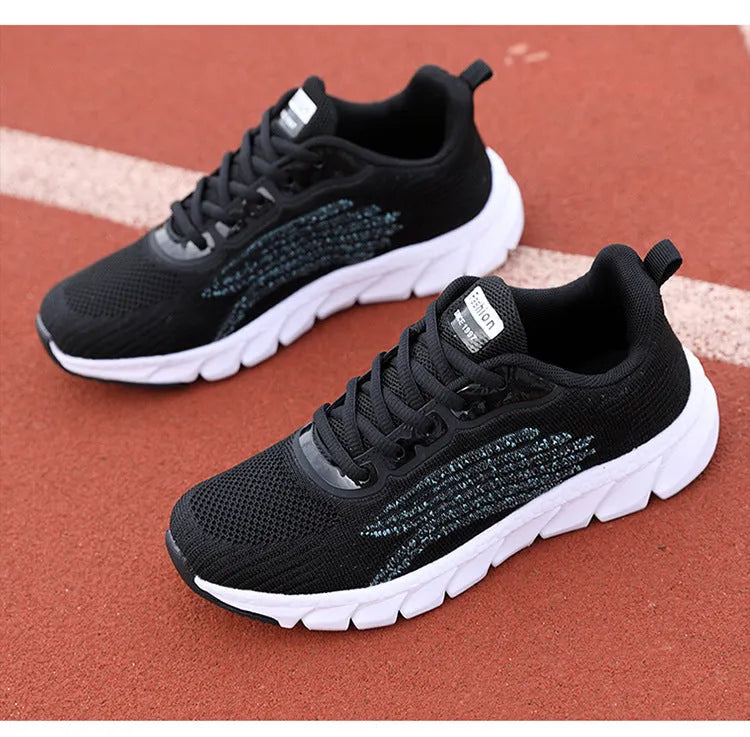 Black and white platform running sneakers with round toe and cross strap details