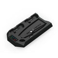 PS5 vertical charging dock stand with cooling fan in black, showing two controllers charging and a headset hanging on hook.