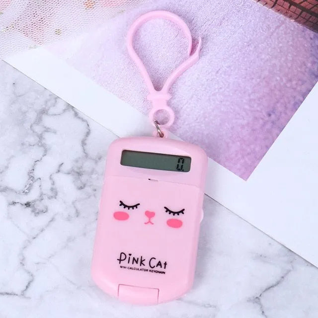 Cookie-shaped mini calculator with key ring in pink, blue, grey, or black, 6.4 x 3.6 x 11.2 cm plastic body