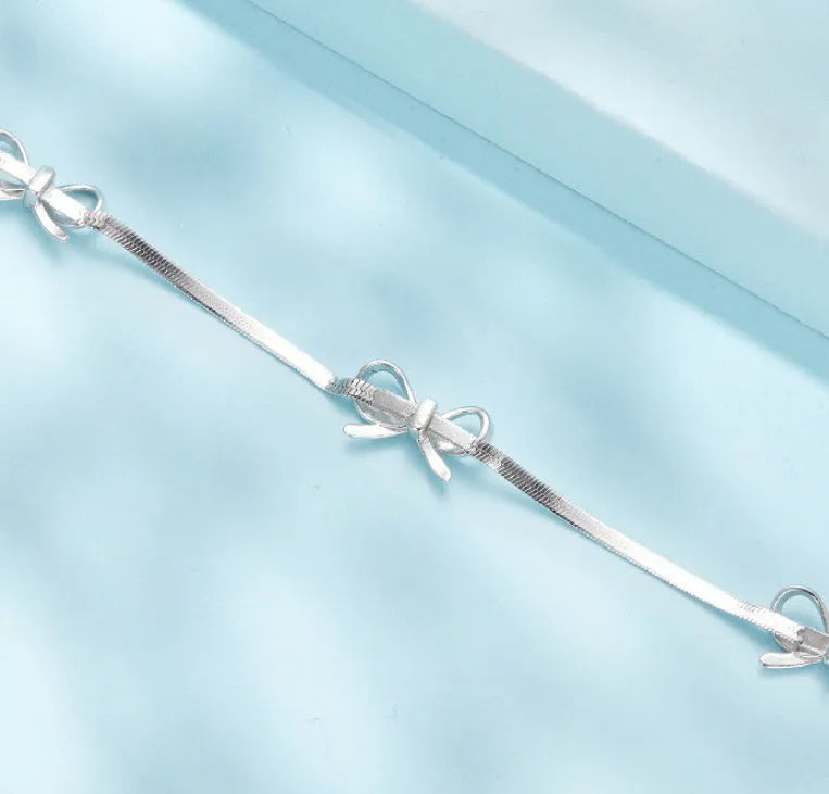 Sterling silver bow bracelet with romantic fairy style on white background