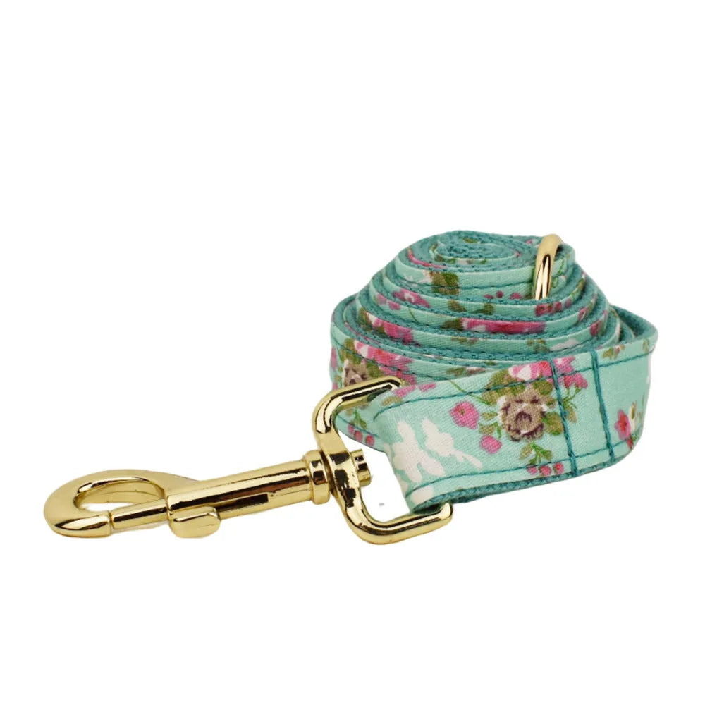 Fabric dog collar set with detachable green rose pattern bow, matching leash and vest