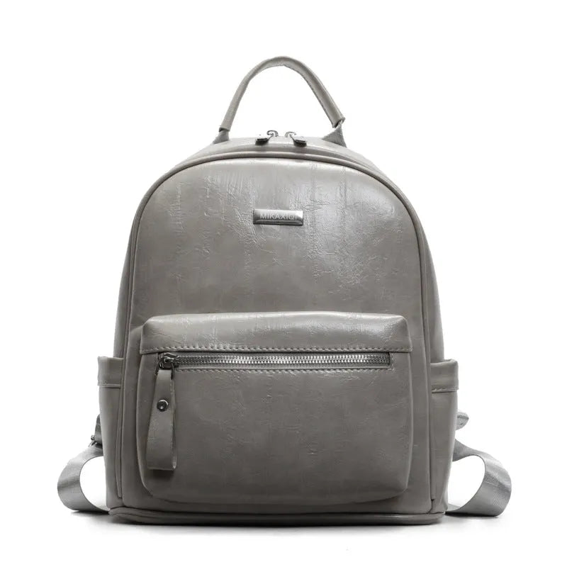 Simple fashion trendy ladies travel backpack in waterproof PU with sandwich pocket, available in multiple colours