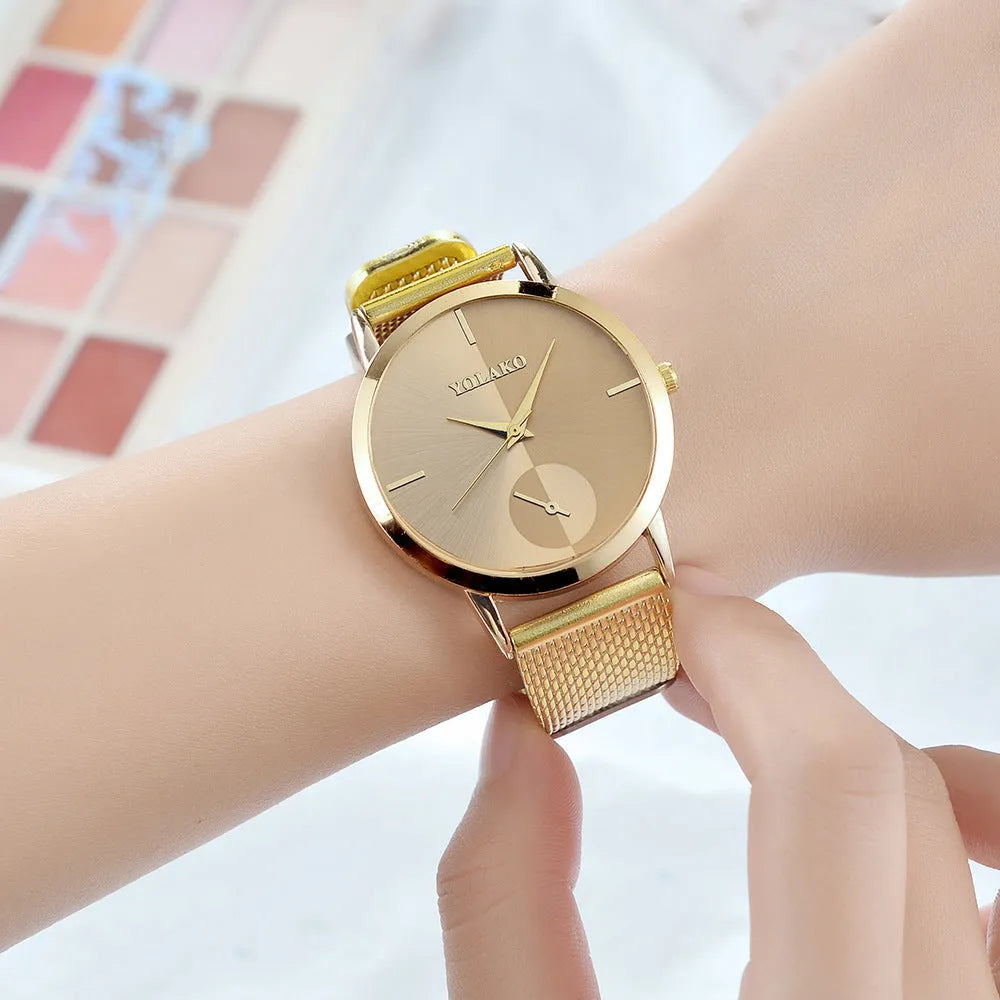 Simple ladies quartz watch with stainless steel strap, 40mm black dial, and mineral glass mirror on neutral background