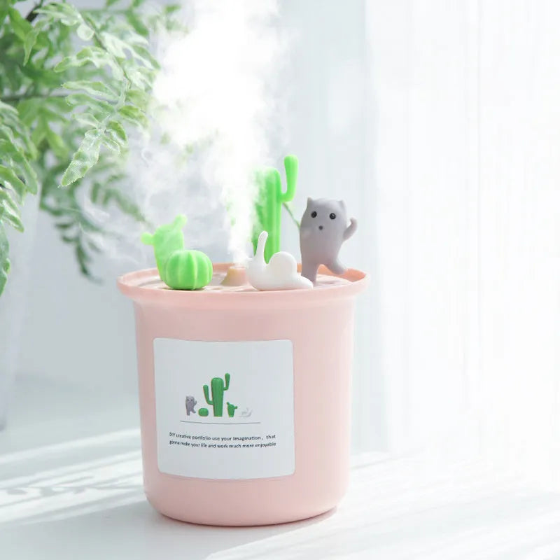 Vase-shaped ultrasonic pet humidifier in cherry blossom pink, with USB cable and water tank.