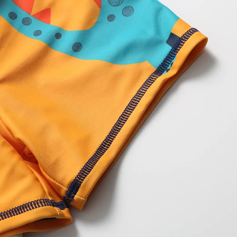 Cartoon dinosaur swimming trunks set for boys in light blue, dark blue, and orange colours