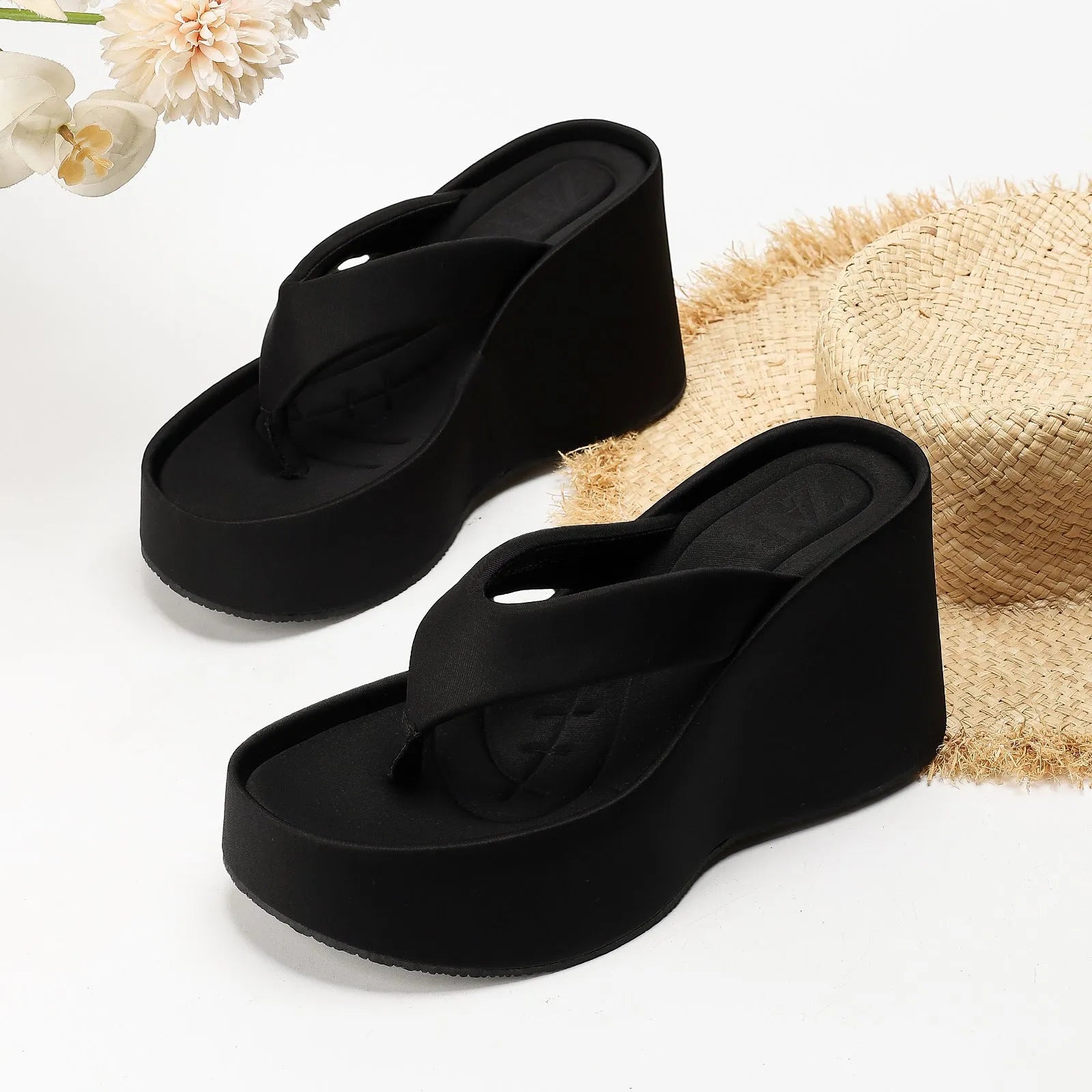 Pair of thick soled slippers for women with PU upper and rubber sole