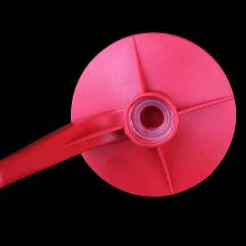 Red plastic Magic Tap soda dispenser attached to inverted 2-litre bottle