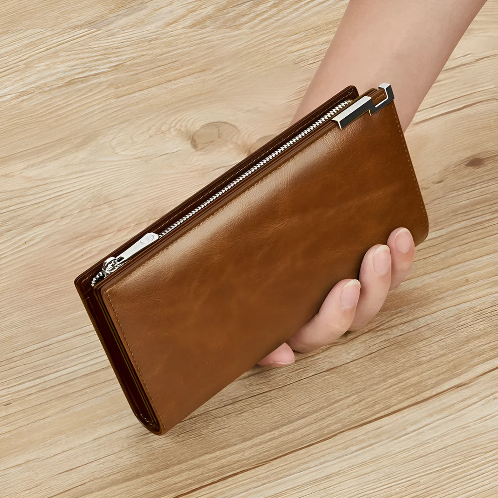 Brown solid colour cowhide leather wallet with contrast stitching laid open showing card slots and cash compartment