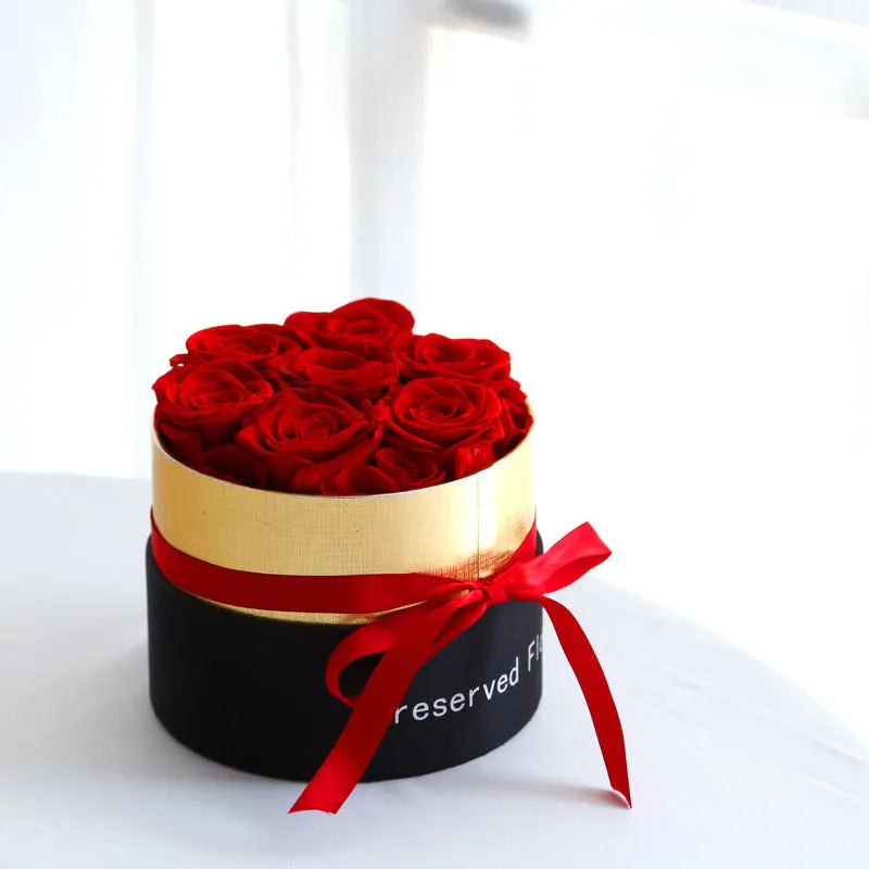 Luxury gift box open to display preserved real red roses, a Valentine's Day gift set.