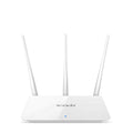 White dual-band wireless broadband router with UK-style three-pin plug on a wooden desk.