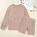 Dark khaki ribbed lantern sleeve sweater and motorcycle knit shorts set on display