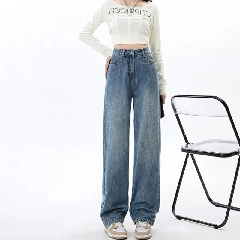 Women's retro blue high-waisted wide-leg denim jeans on a hanger, showing the straight-leg cut.