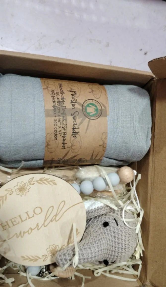Baby teething gift set with bamboo gauze blanket, wooden chewing ring, woven bell, and developmental toys