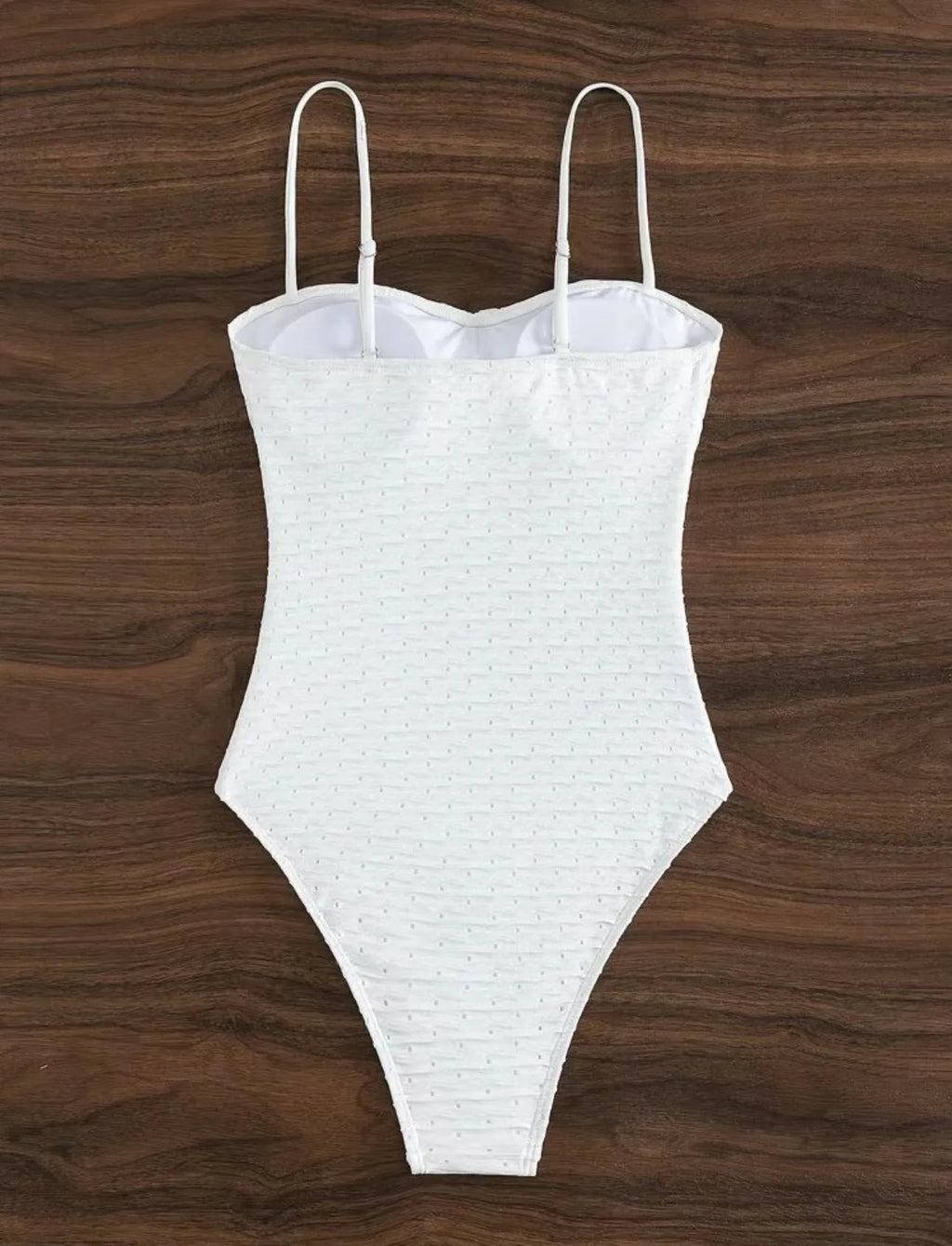White sling-style one-piece swimsuit for women on a mannequin