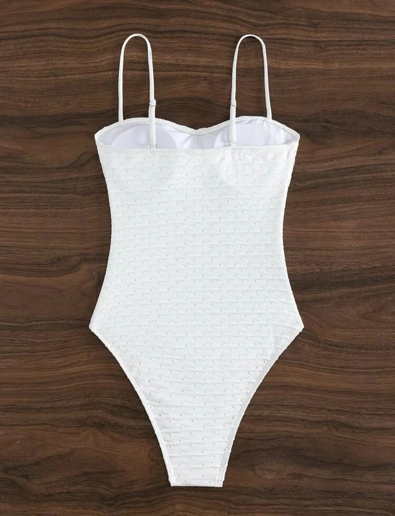 White sling-style one-piece swimsuit for women on a mannequin